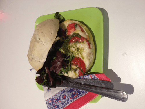 Mozzarella, tomato and green pesto sandwich (warm from the oven)