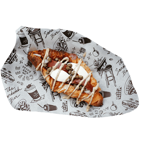 Croissant topped with raw beef sausage